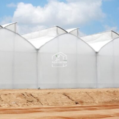 A modern butterfly vent naturally ventilated polyhouse installed by JH Agriinfra in India, promoting sustainable and climate-resilient agriculture.
