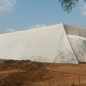 Wire rope supported shade net house structure protecting crops in an agricultural field in India by JH Agriinfra